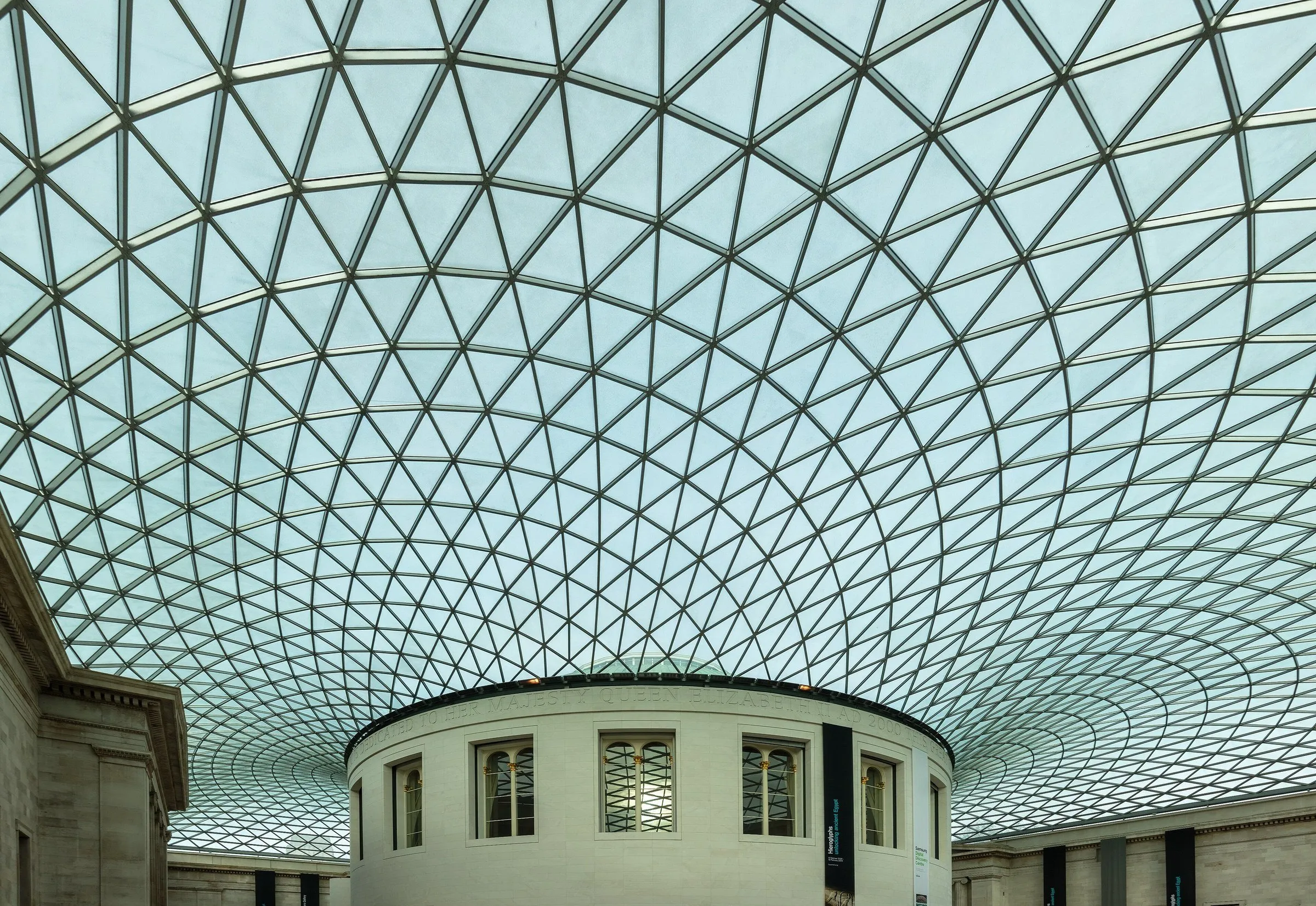 Triangular-mesh glass roof of the British Museum's Great Court, with the old circular reading room below.