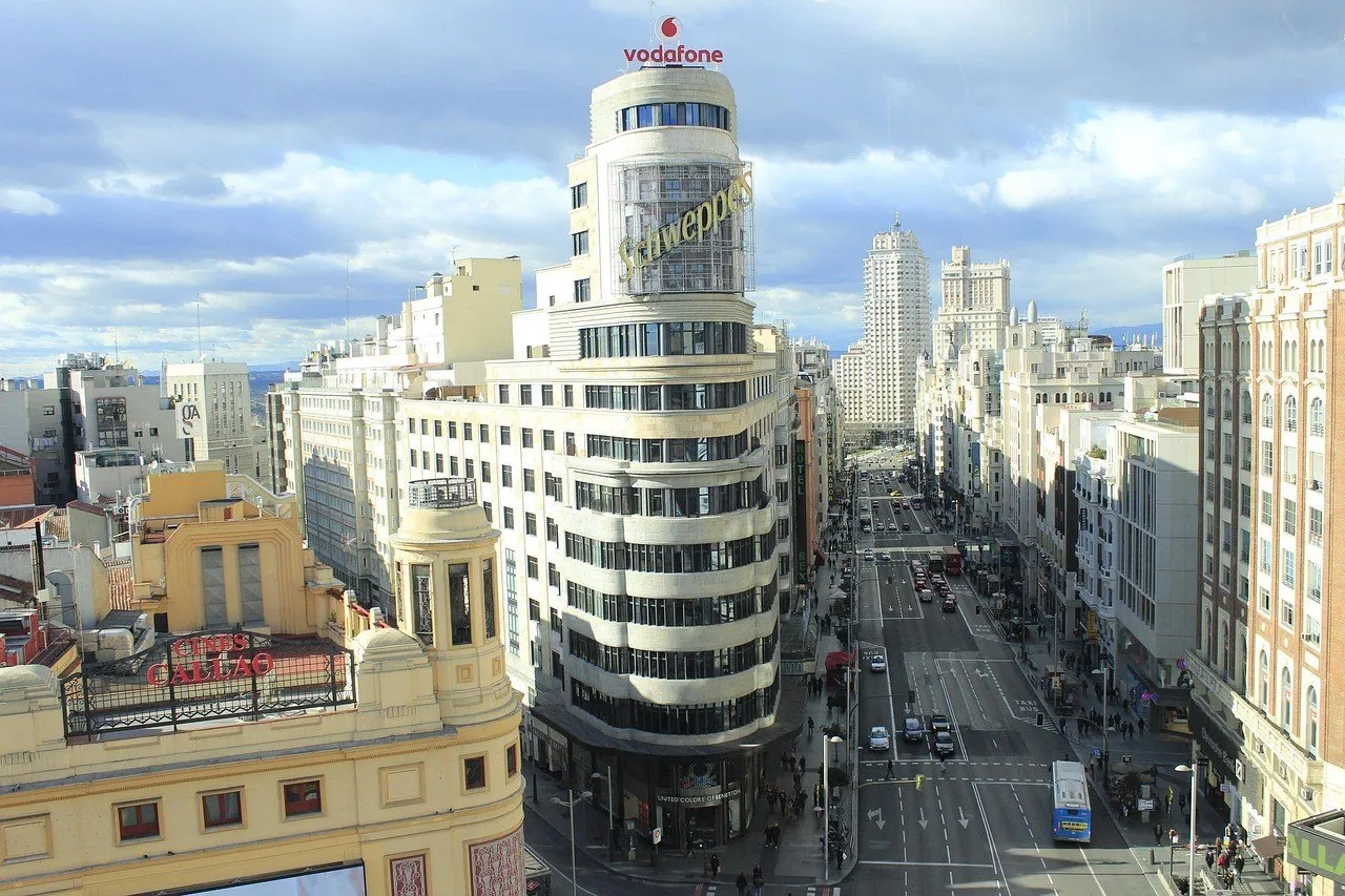 Capitol Building and Gran Vía seen from above, with light-colored facades under a partly cloudy sky.