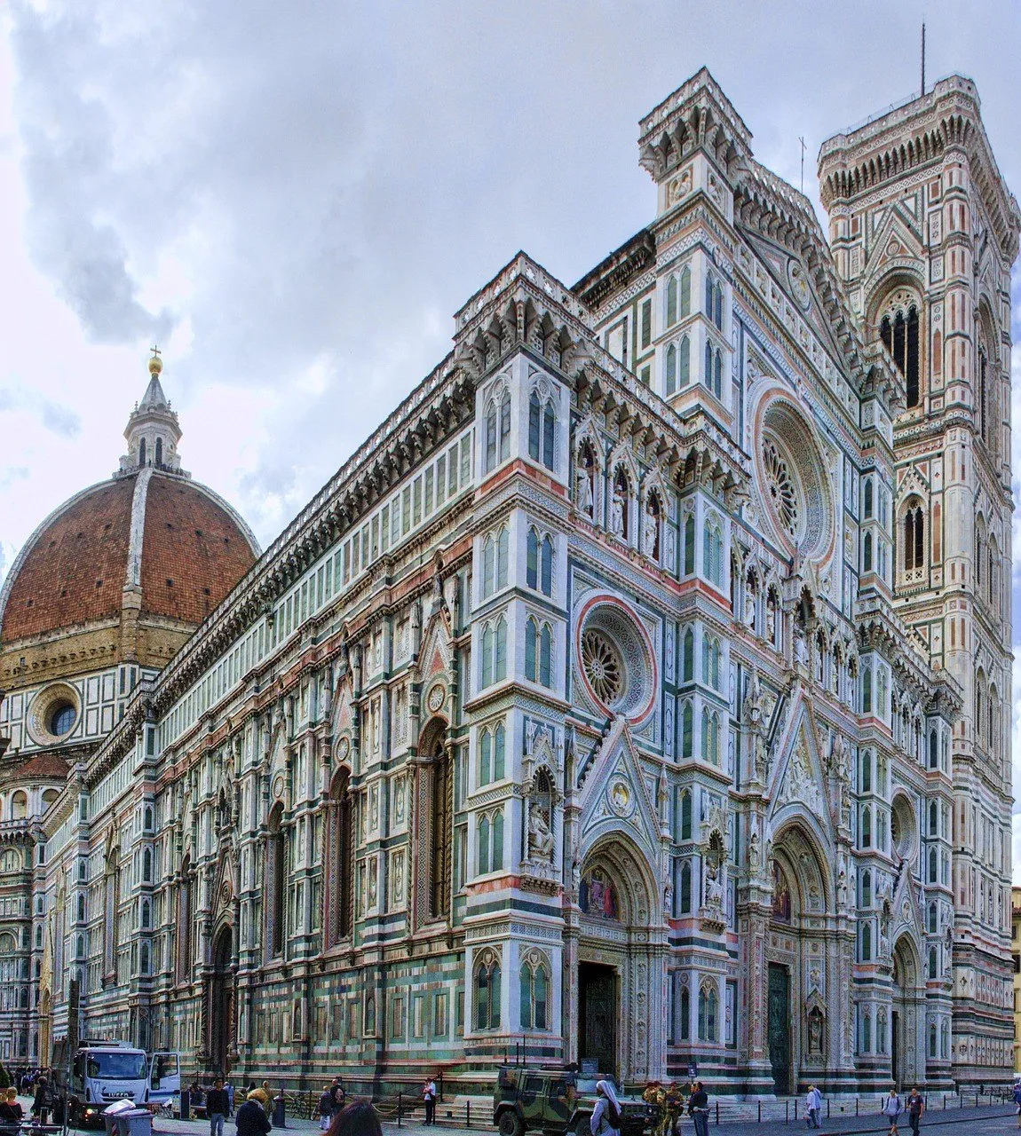 Marble facade, bell tower and dome of Florence Cathedral seen from the square.