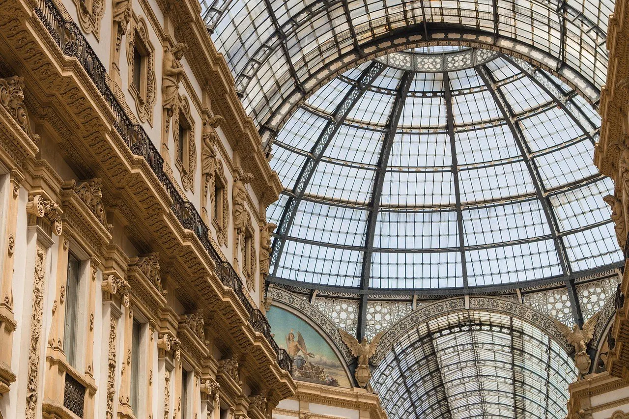 Glass and iron dome of the Galleria Vittorio Emanuele II, between ornate interior façades.