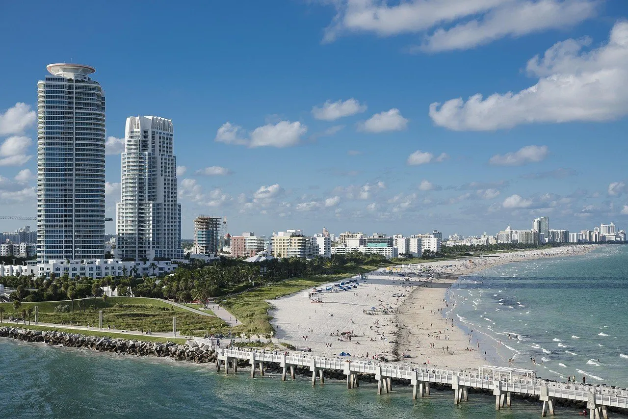 Vista elevada do píer de South Pointe, com parque, praia e prédios de Miami Beach ao fundo.